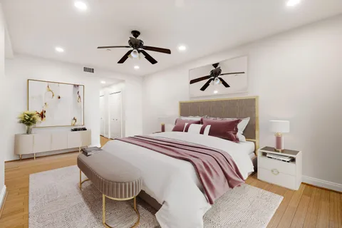 a spacious bedroom with a bed and a chandelier