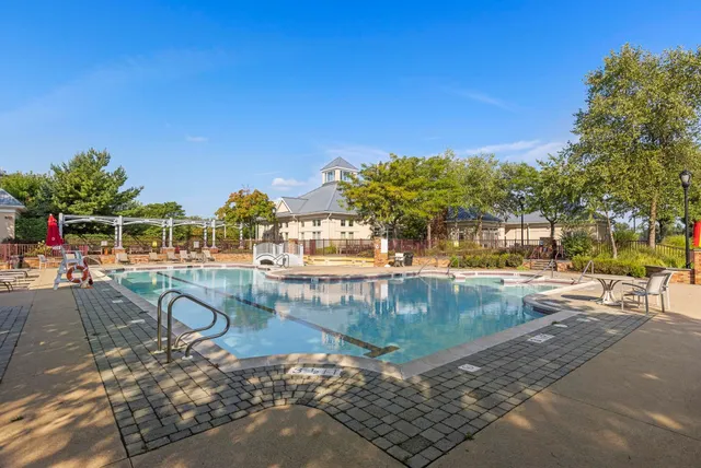 a swimming pool with outdoor seating yard and green space