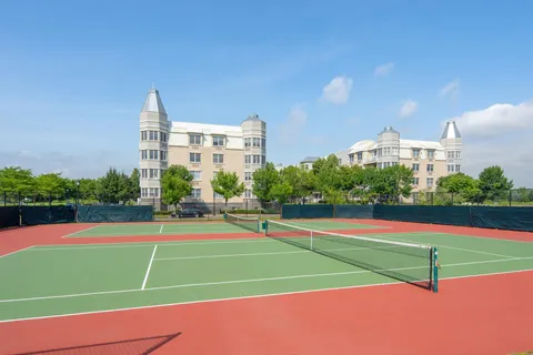 a park with lots of trees and buildings in the background
