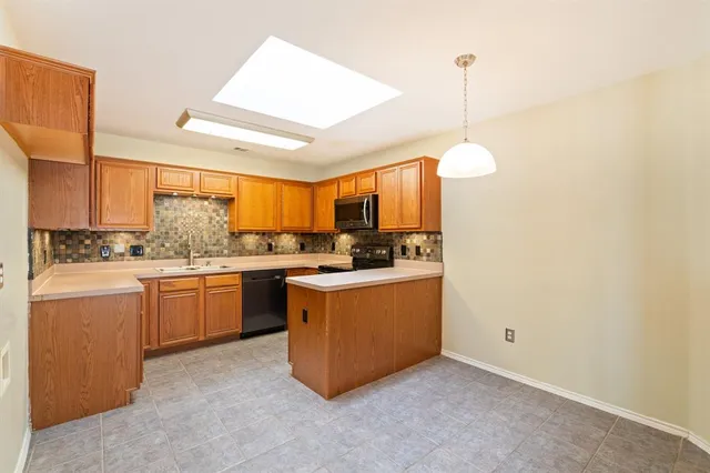 a kitchen with sink and window