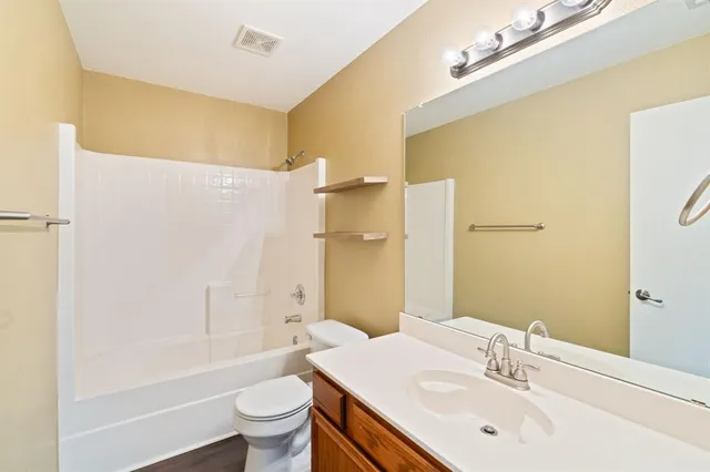 a bathroom with a sink a toilet and shower curtain