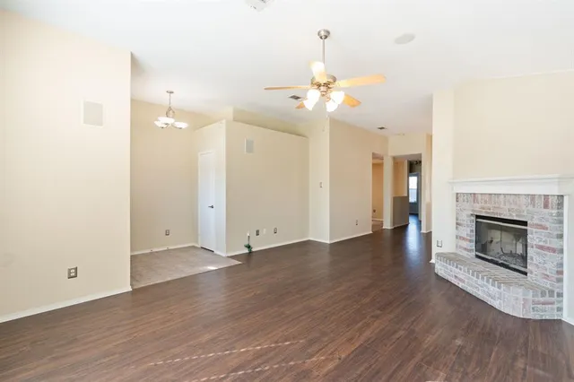 a view of a room with wooden floor and a fireplace