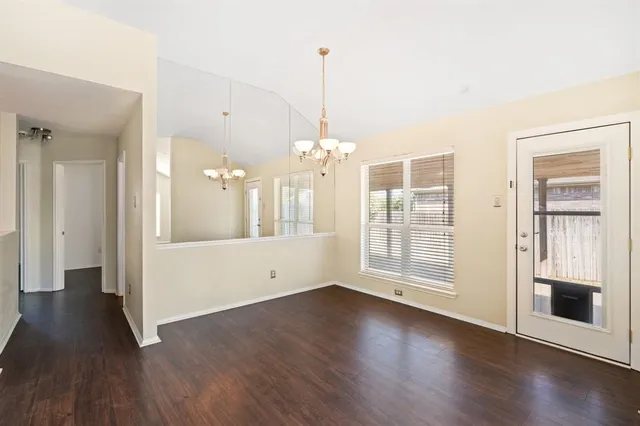 a view of a room with wooden floor and windows
