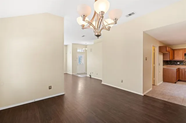a view of a room with wooden floor