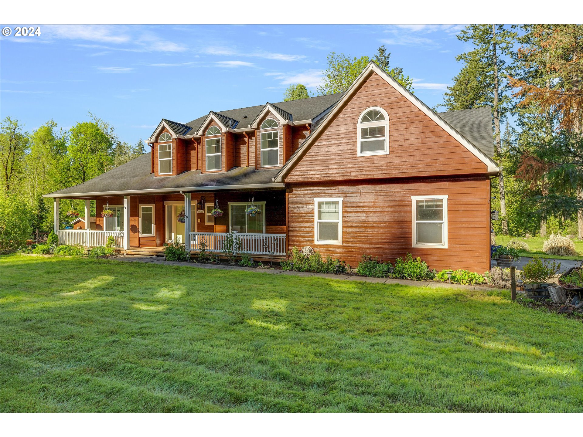 19053 South Mattoon Road Estacada, OR 97023 - Photo 1 of 47 a front view of a house with a garden