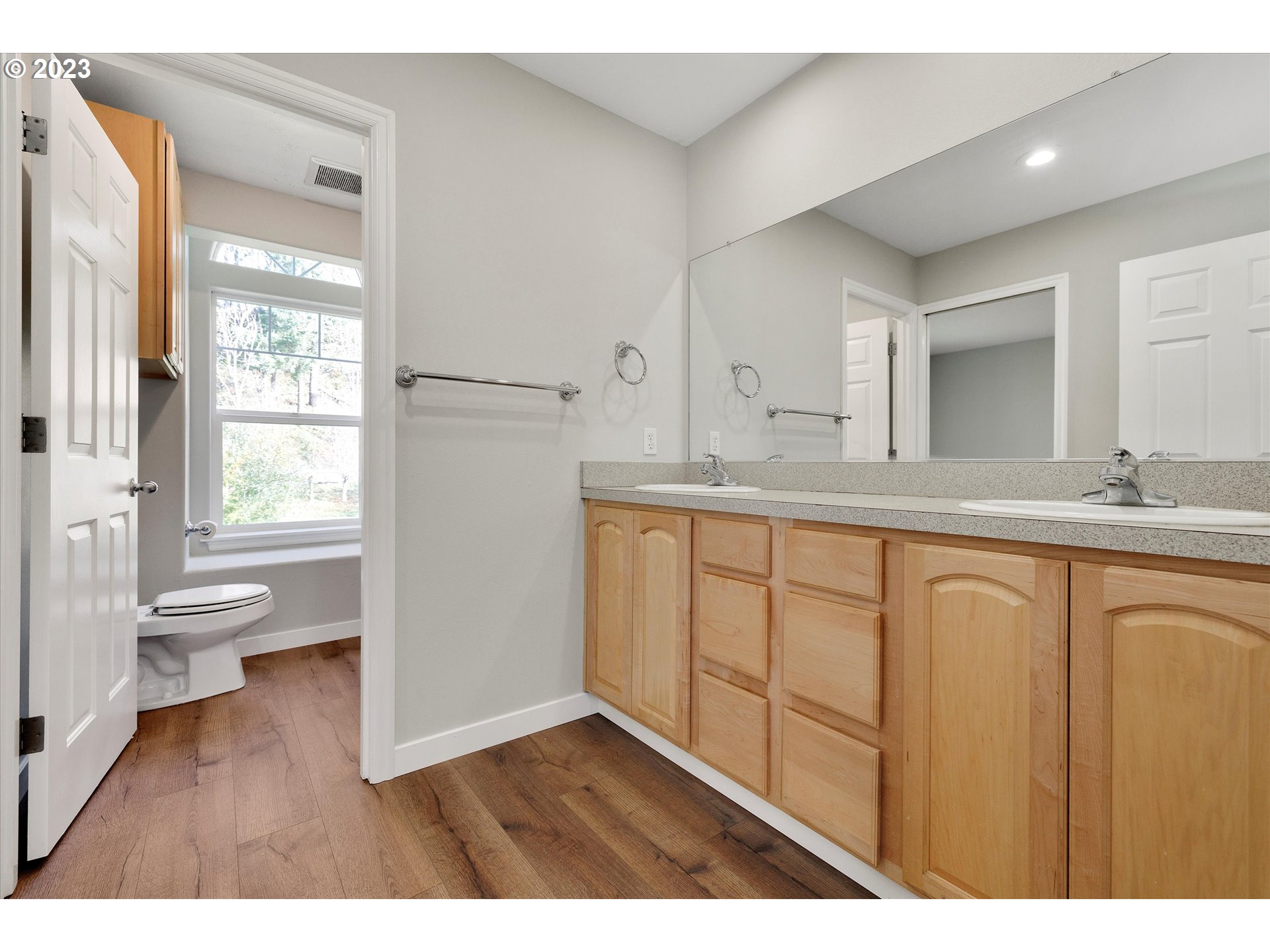 19053 South Mattoon Road Estacada, OR 97023 - Photo 33 of 47 a bathroom with a granite countertop sink toilet a large mirror a vanity and