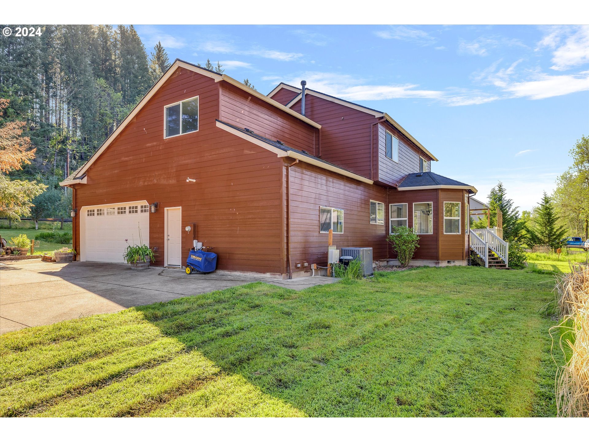 19053 South Mattoon Road Estacada, OR 97023 - Photo 36 of 47 a front view of a house with a yard and garage