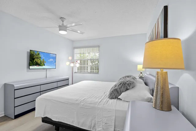 a bedroom with a bed and a lamp on table