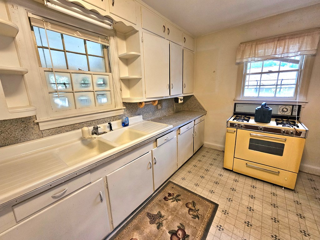 752 Portland Avenue Columbus, GA 31906 - Photo 14 of 31 a kitchen with stainless steel appliances granite countertop a sink stove and cabinets