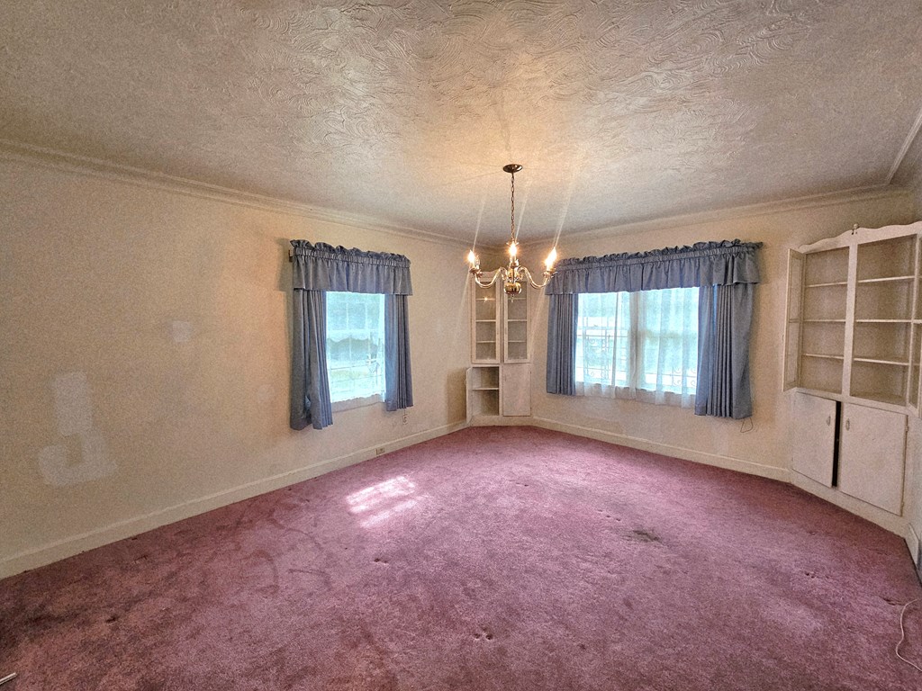 752 Portland Avenue Columbus, GA 31906 - Photo 20 of 31 an empty room with windows and chandelier