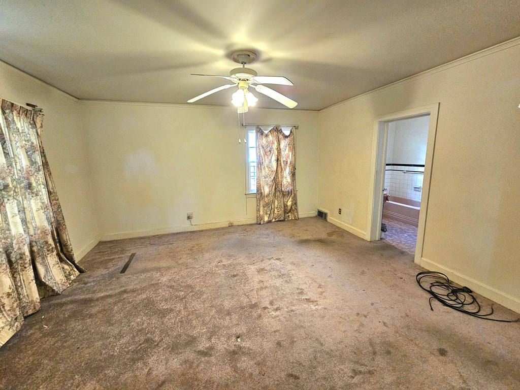 752 Portland Avenue Columbus, GA 31906 - Photo 28 of 31 a view of an empty room with window and chandelier fan