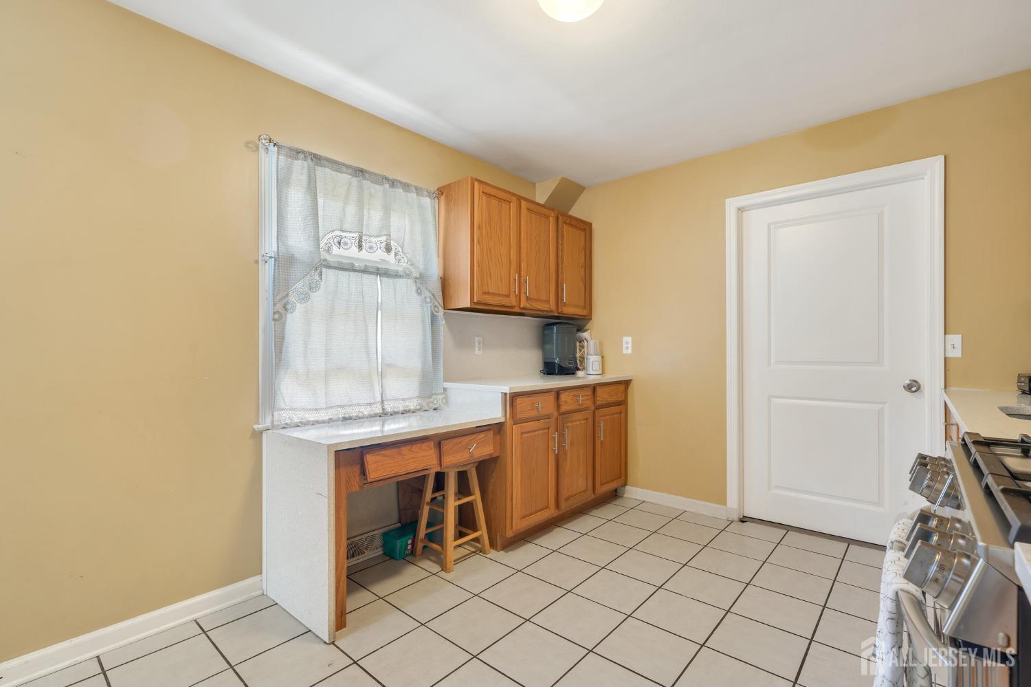 12 Pierrepont Avenue Middlesex, NJ 08846 - Photo 9 of 30 a kitchen with granite countertop cabinets and chair