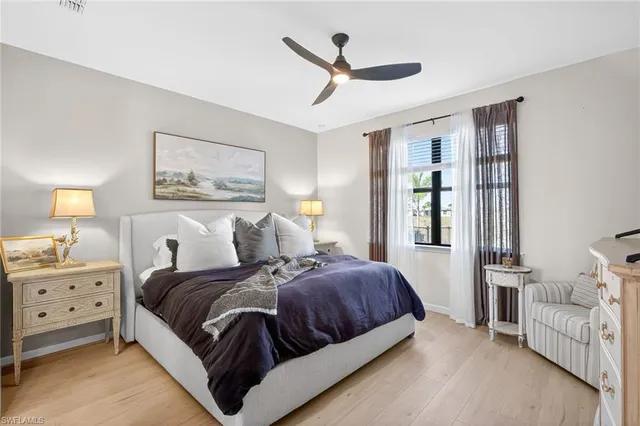 a spacious bedroom with a bed and a window