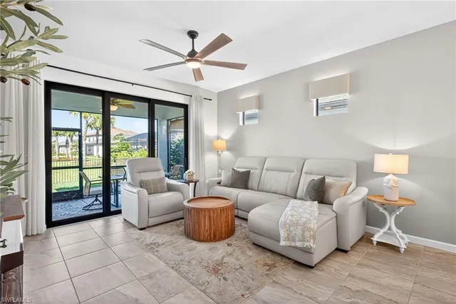 a living room with furniture and a large window with wooden floor