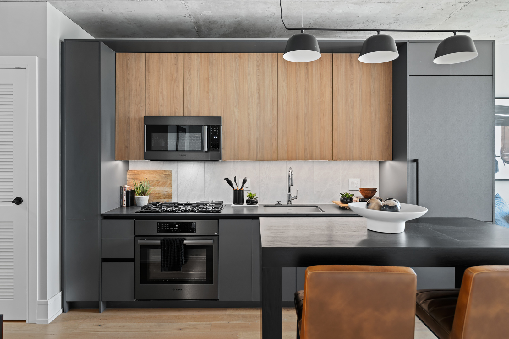 234 West Polk Street, Unit 3206 Chicago, IL 60607 - Photo 4 of 30 a kitchen with stainless steel appliances granite countertop a sink stove and microwave