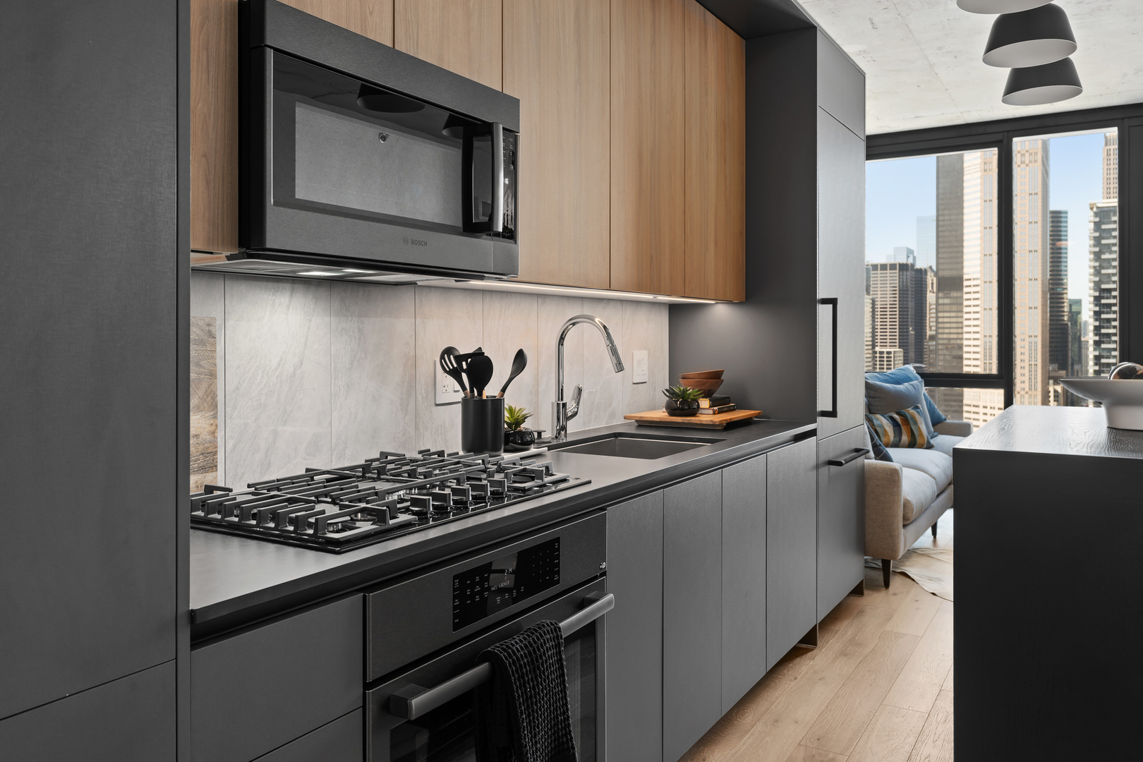 234 West Polk Street, Unit 3206 Chicago, IL 60607 - Photo 5 of 30 a kitchen with stainless steel appliances a stove a sink and a microwave