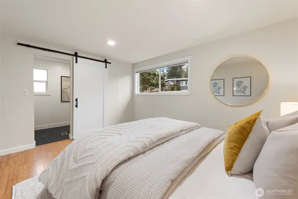 a bedroom with a bed and a painting