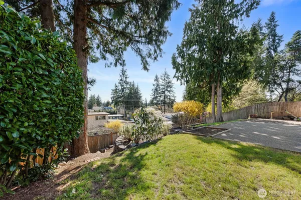 a view of yard with swimming pool and trees