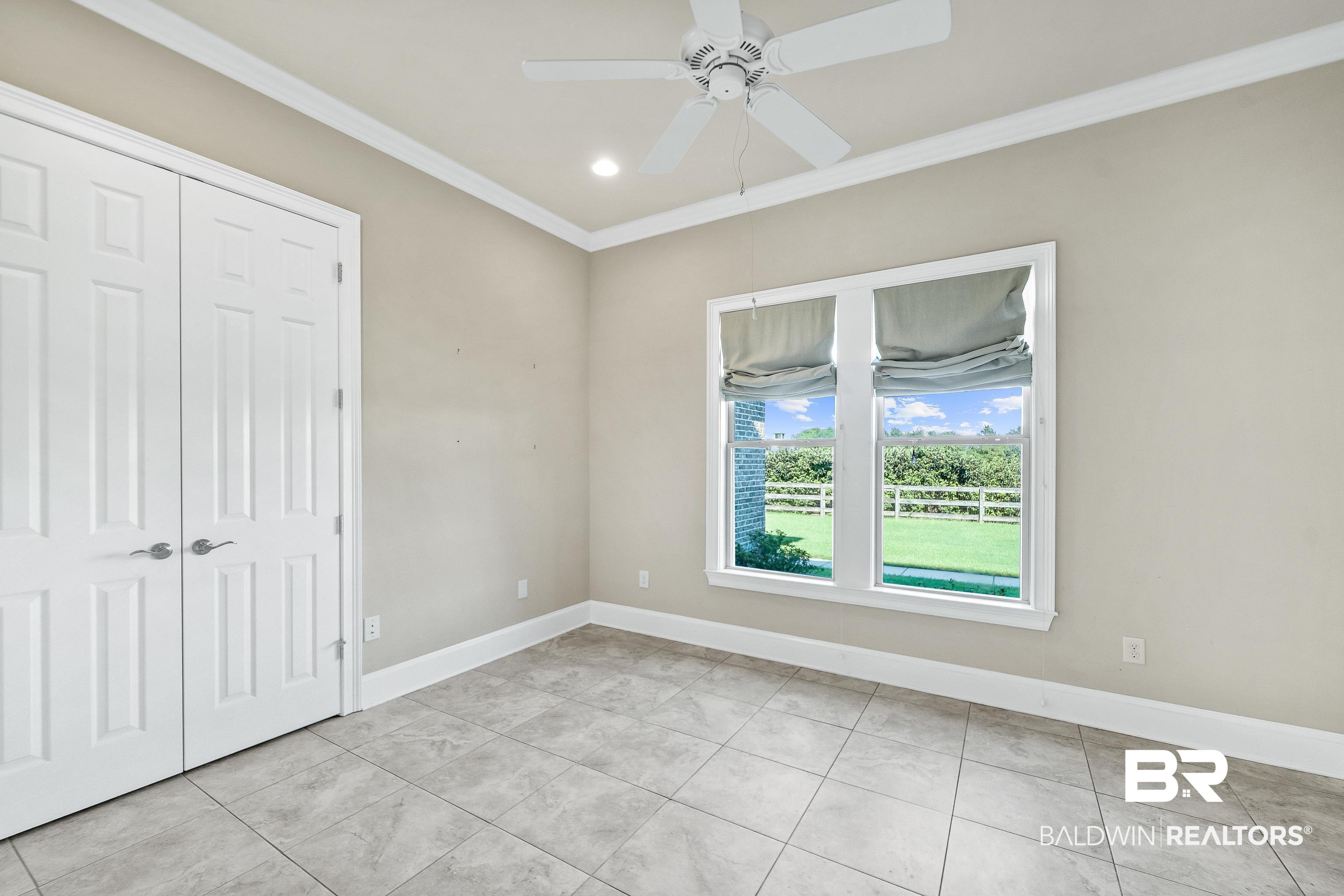 17663 Burwick Loop Fairhope, AL 36532 - Photo 19 of 41 Unfurnished bedroom featuring ornamental molding, ceiling fan, and a closet