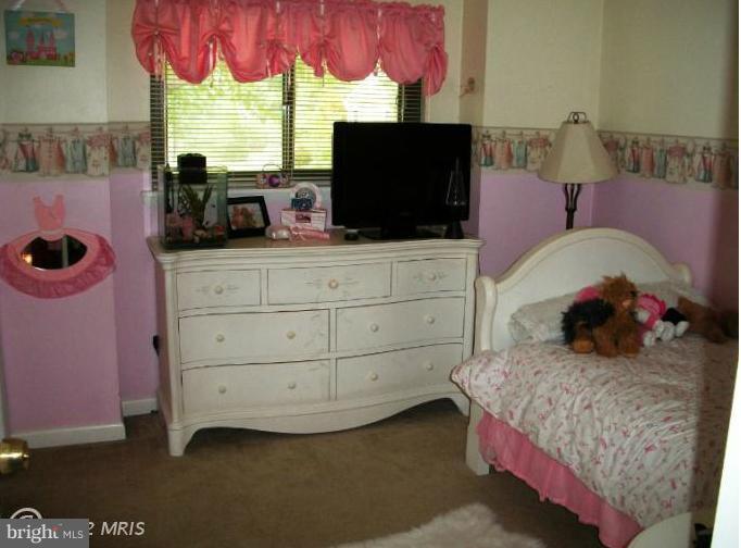 897 Beech Tree Road Severn, MD 21144 - Photo 11 of 30 a bedroom with a bed window and flat screen tv