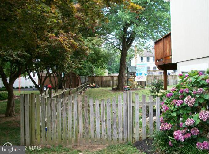 897 Beech Tree Road Severn, MD 21144 - Photo 13 of 30 a view of a house with a small yard and wooden fence