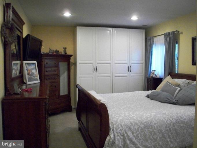 897 Beech Tree Road Severn, MD 21144 - Photo 16 of 30 a bedroom with a bed and a television