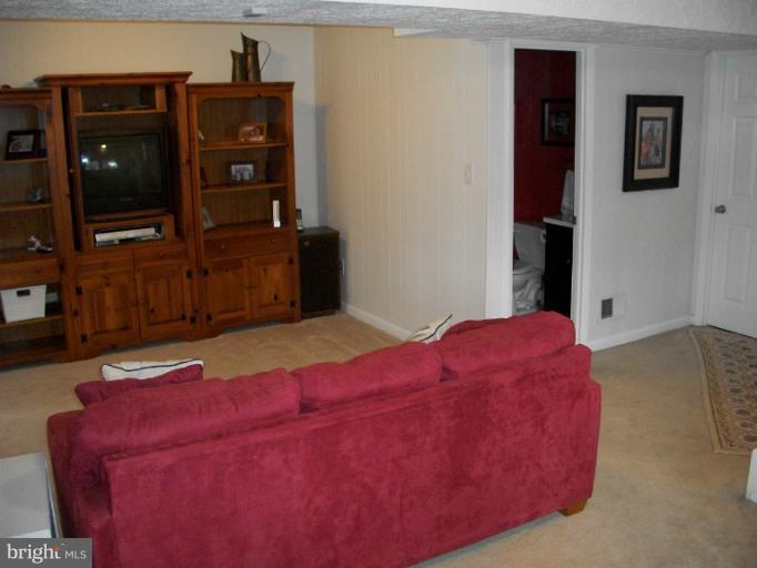 897 Beech Tree Road Severn, MD 21144 - Photo 20 of 30 a bedroom with a bed and a television