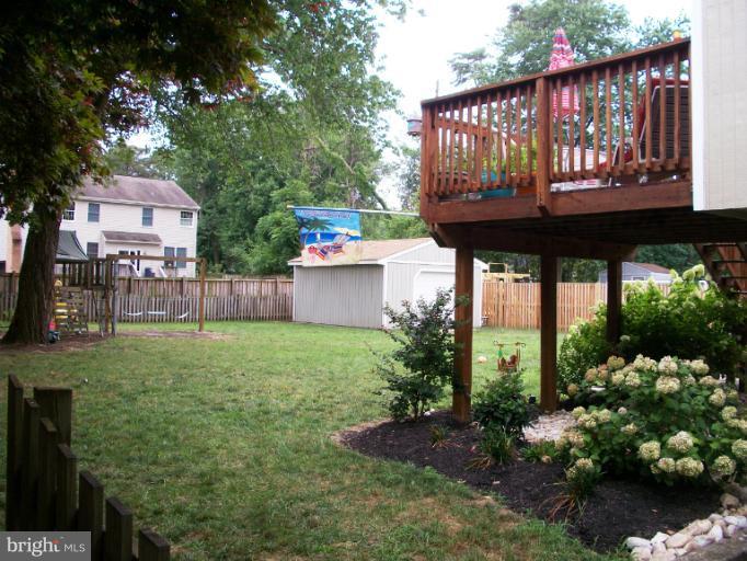 897 Beech Tree Road Severn, MD 21144 - Photo 21 of 30 a view of a back yard with a table and chairs