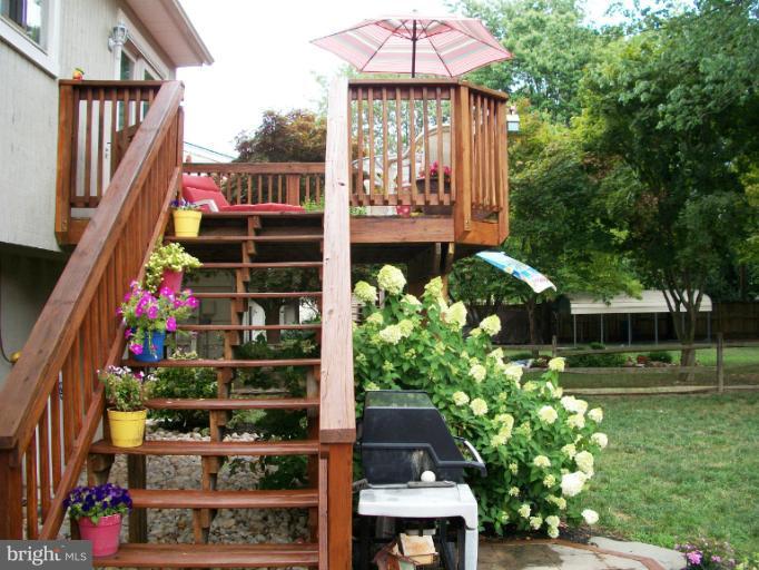 897 Beech Tree Road Severn, MD 21144 - Photo 26 of 30 a view of a house with a garden and plants