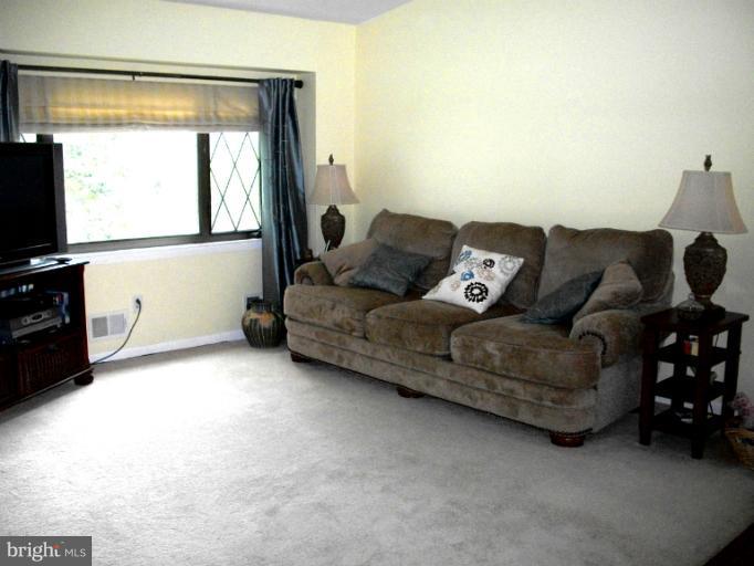 897 Beech Tree Road Severn, MD 21144 - Photo 28 of 30 a living room with furniture and a flat screen tv