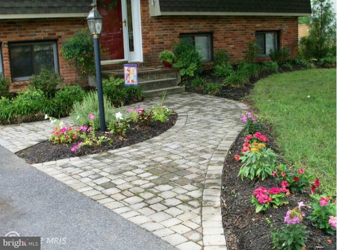 897 Beech Tree Road Severn, MD 21144 - Photo 5 of 30 a flower garden in front of a building