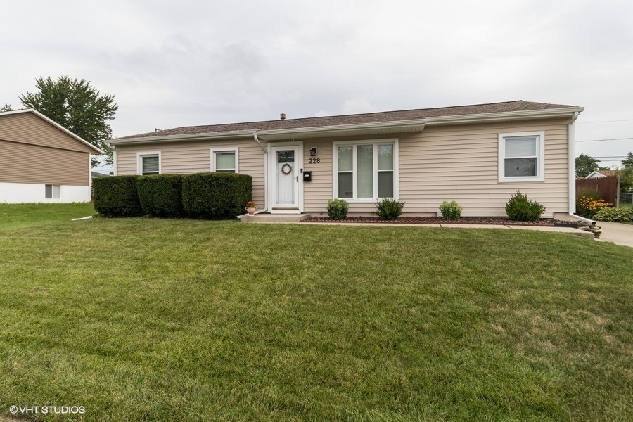 228 Murphy Drive Romeoville, IL 60446 - Photo 1 of 20 a front view of house with yard patio and green space