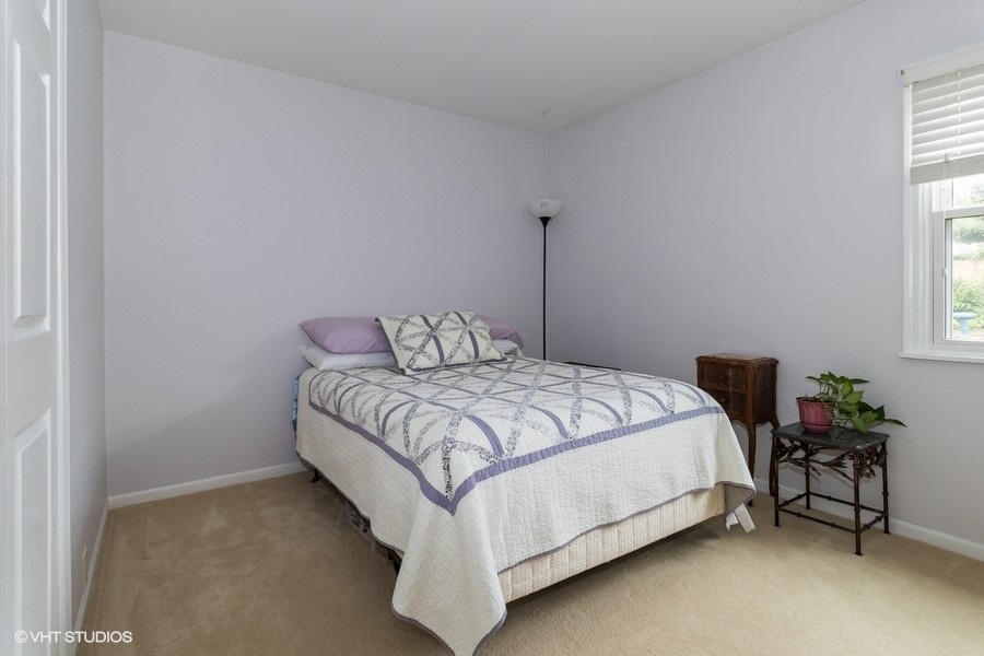 228 Murphy Drive Romeoville, IL 60446 - Photo 13 of 20 a bedroom with a bed and a table