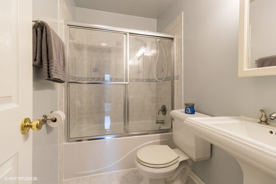228 Murphy Drive Romeoville, IL 60446 - Photo 14 of 20 a bathroom with a sink toilet and shower