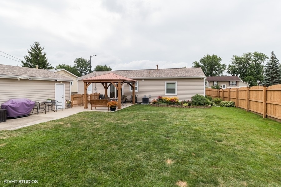 228 Murphy Drive Romeoville, IL 60446 - Photo 18 of 20 a view of a house with backyard and porch