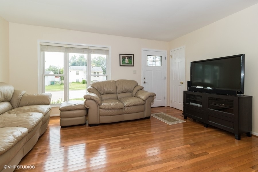228 Murphy Drive Romeoville, IL 60446 - Photo 5 of 20 a living room with furniture and a flat screen tv