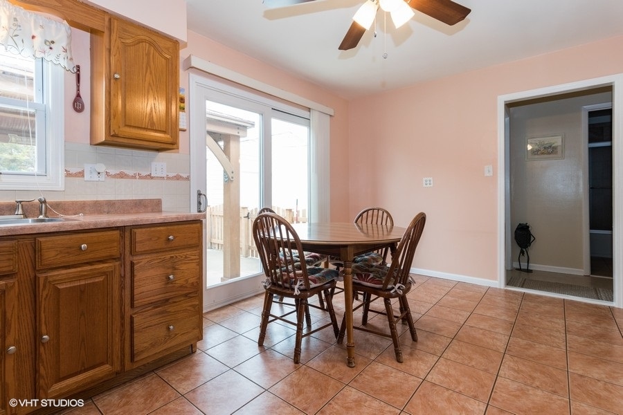 228 Murphy Drive Romeoville, IL 60446 - Photo 8 of 20 a view of a dining room with furniture and chandelier