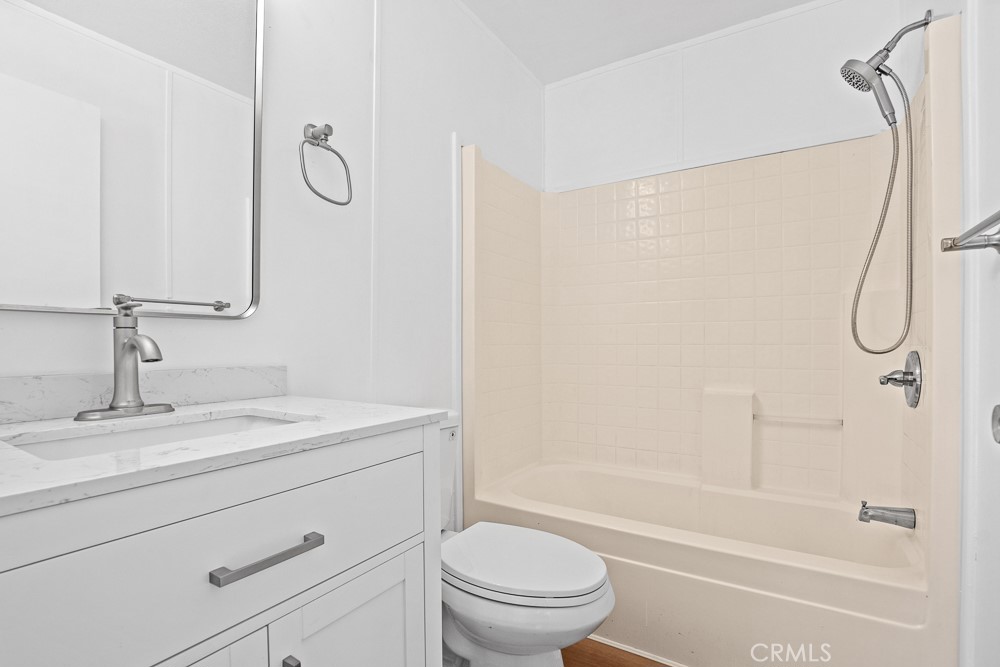 20401 Soledad Canyon Road, Unit 355 Canyon Country, CA 91351 - Photo 13 of 36 a bathroom with a granite countertop sink a toilet and shower