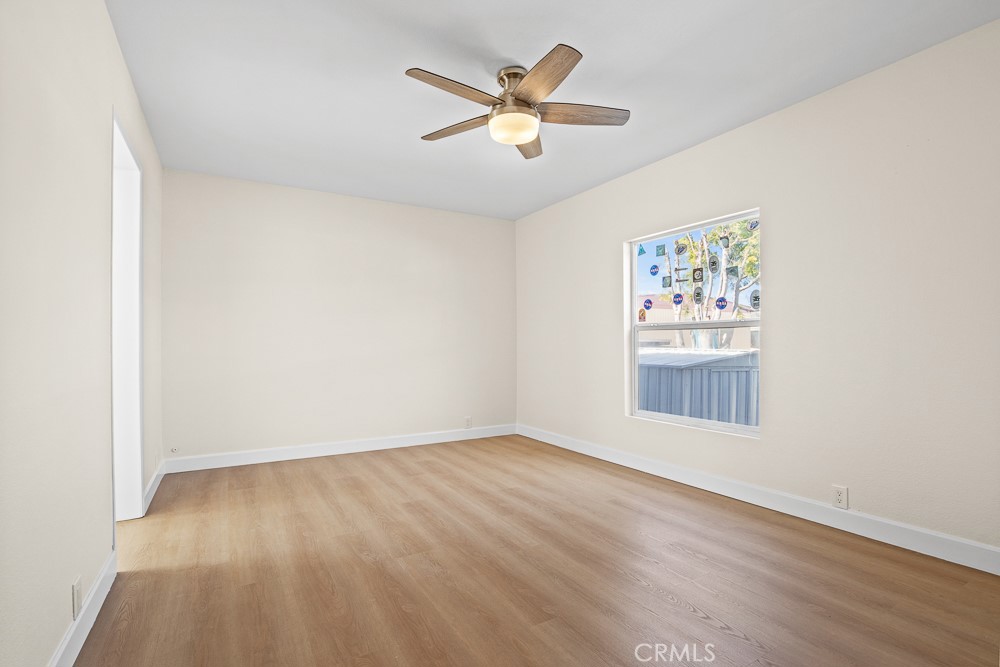 20401 Soledad Canyon Road, Unit 355 Canyon Country, CA 91351 - Photo 14 of 36 an empty room with wooden floor and windows
