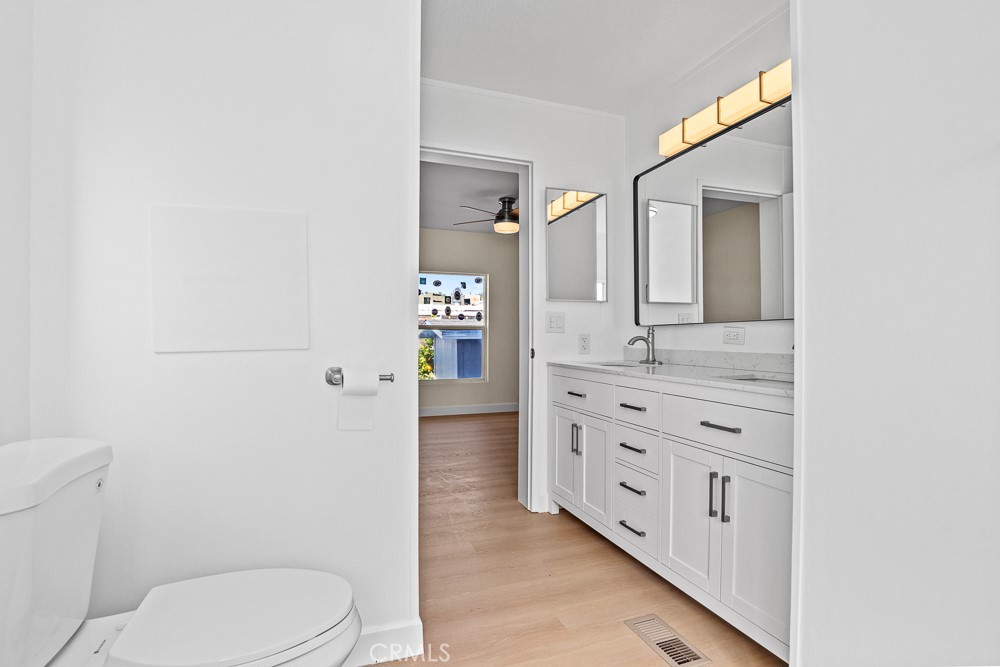 20401 Soledad Canyon Road, Unit 355 Canyon Country, CA 91351 - Photo 18 of 36 a bathroom with a granite countertop toilet sink and mirror
