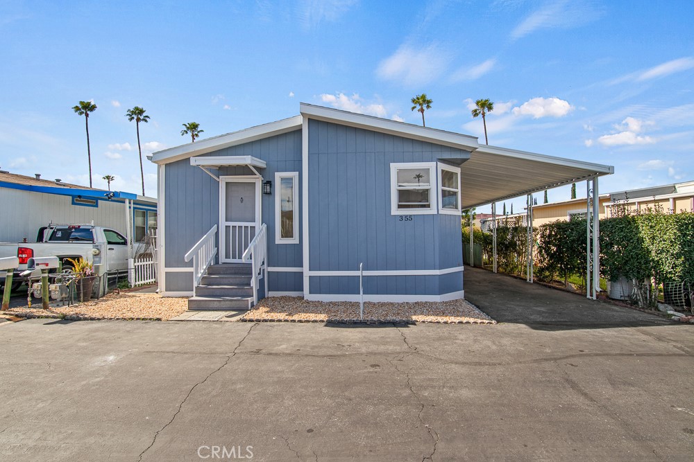 20401 Soledad Canyon Road, Unit 355 Canyon Country, CA 91351 - Photo 19 of 36 a view of a house with porch and furniture