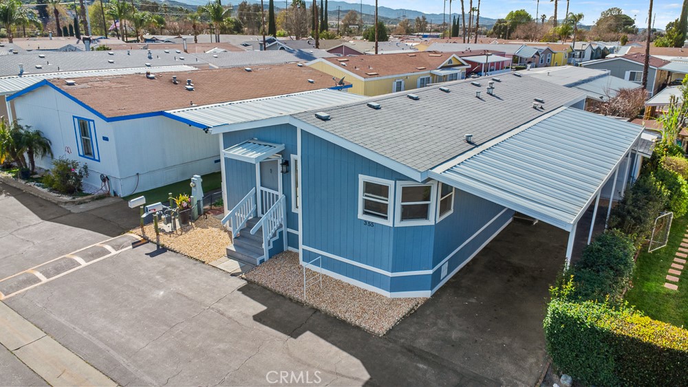 20401 Soledad Canyon Road, Unit 355 Canyon Country, CA 91351 - Photo 27 of 36 a view of a house with a patio and a yard