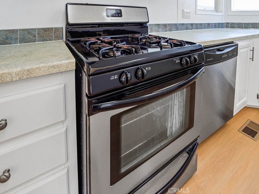 20401 Soledad Canyon Road, Unit 355 Canyon Country, CA 91351 - Photo 3 of 36 a stove top oven sitting inside of a kitchen