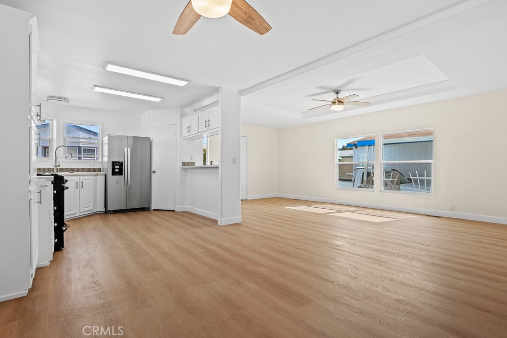 20401 Soledad Canyon Road, Unit 355 Canyon Country, CA 91351 - Photo 5 of 36 a view of empty room with wooden floor and windows