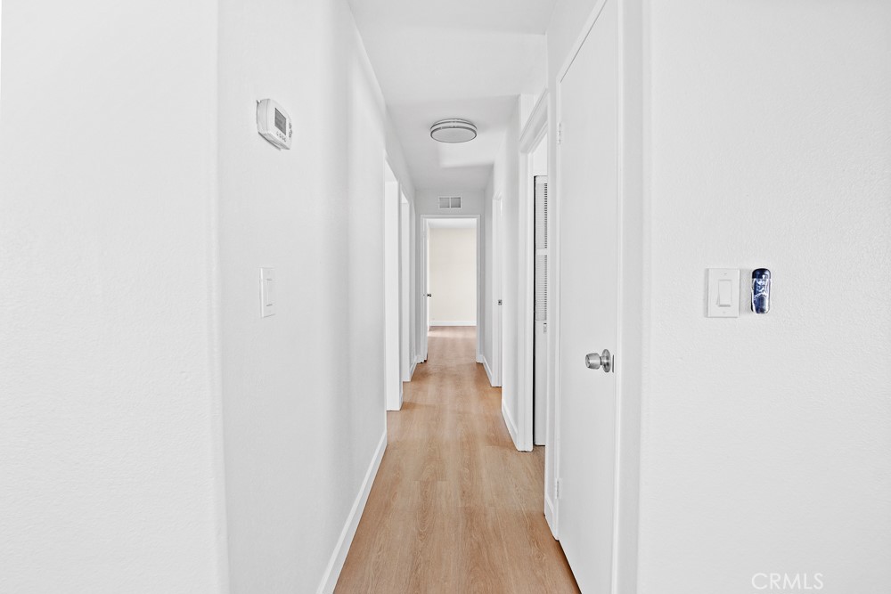 20401 Soledad Canyon Road, Unit 355 Canyon Country, CA 91351 - Photo 9 of 36 a view of a hallway with wooden floor