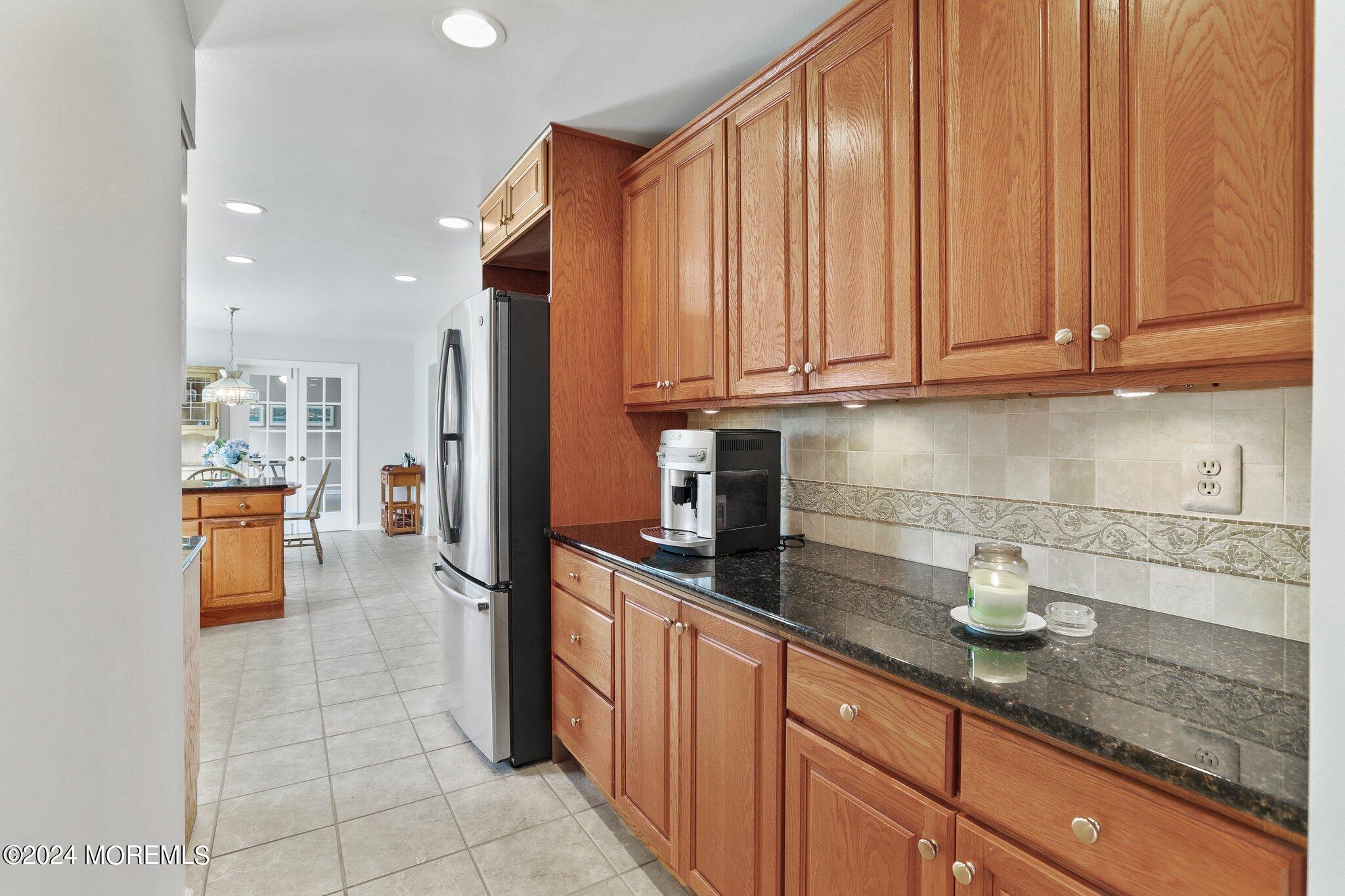 234 Yale Drive Lincroft, NJ 07738 - Photo 13 of 38 a kitchen with stainless steel appliances granite countertop a sink a stove and cabinets