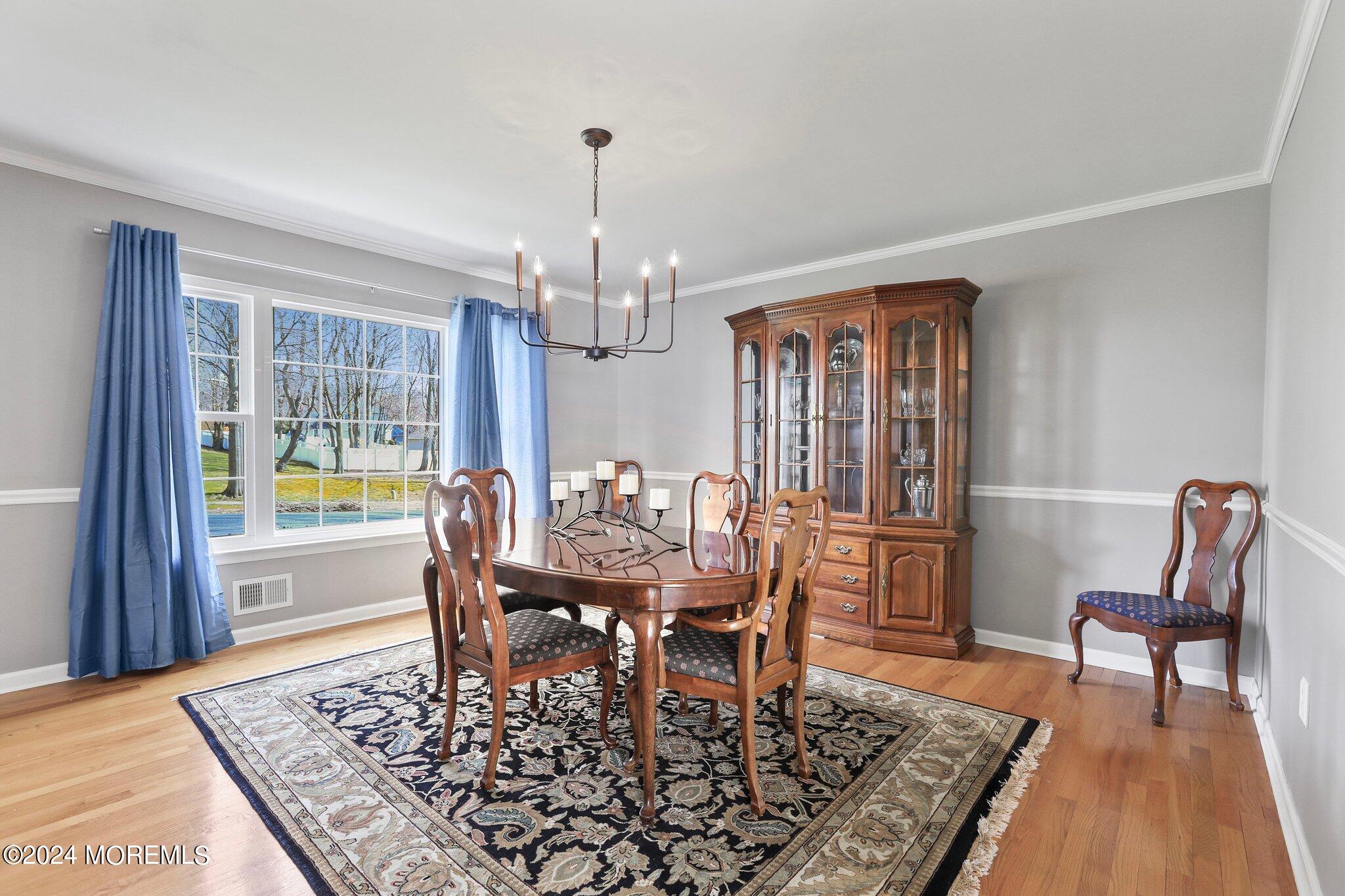 234 Yale Drive Lincroft, NJ 07738 - Photo 14 of 38 a view of a dining room with furniture window and wooden floor