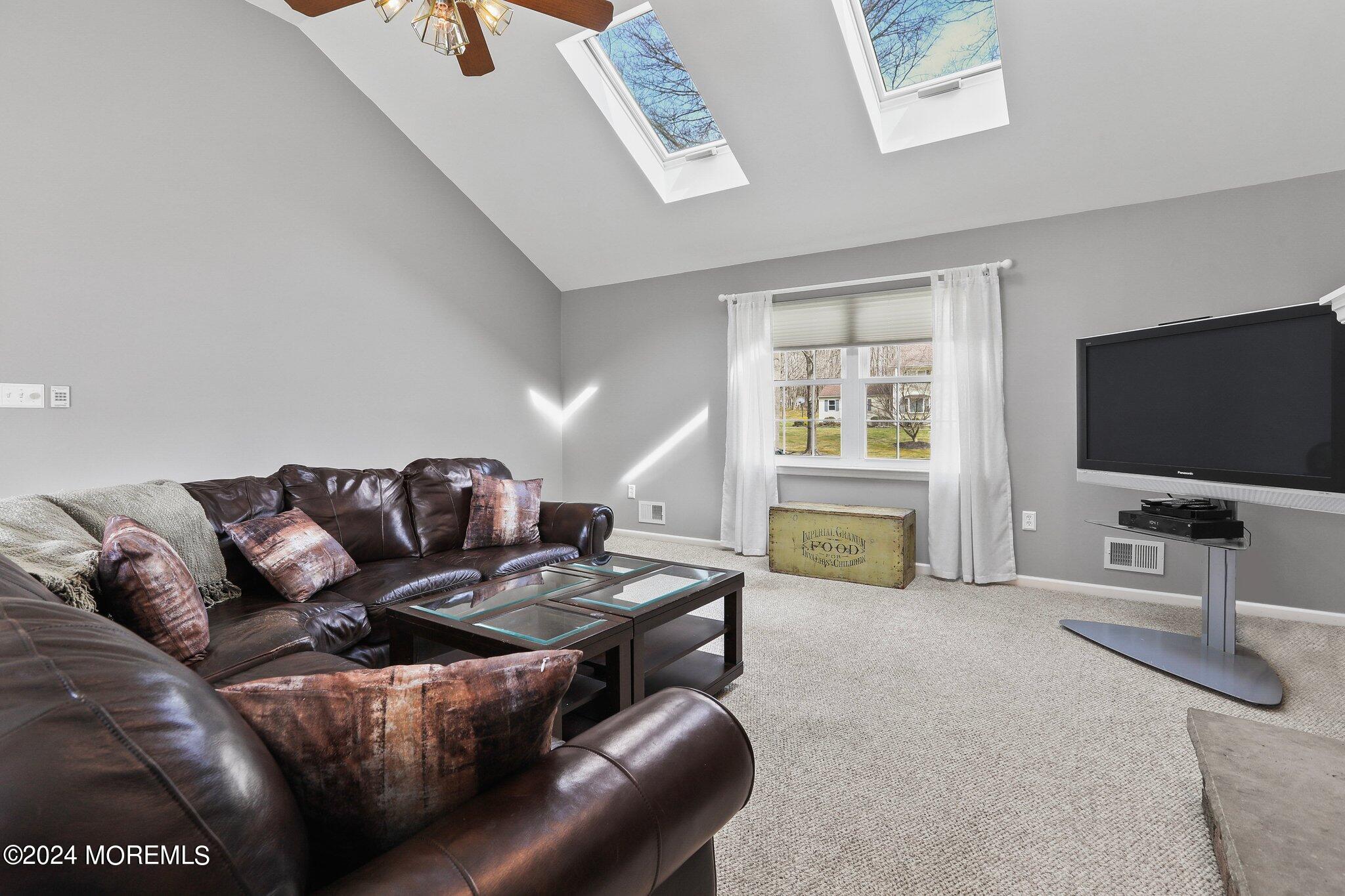 234 Yale Drive Lincroft, NJ 07738 - Photo 18 of 38 a living room with furniture and a flat screen tv