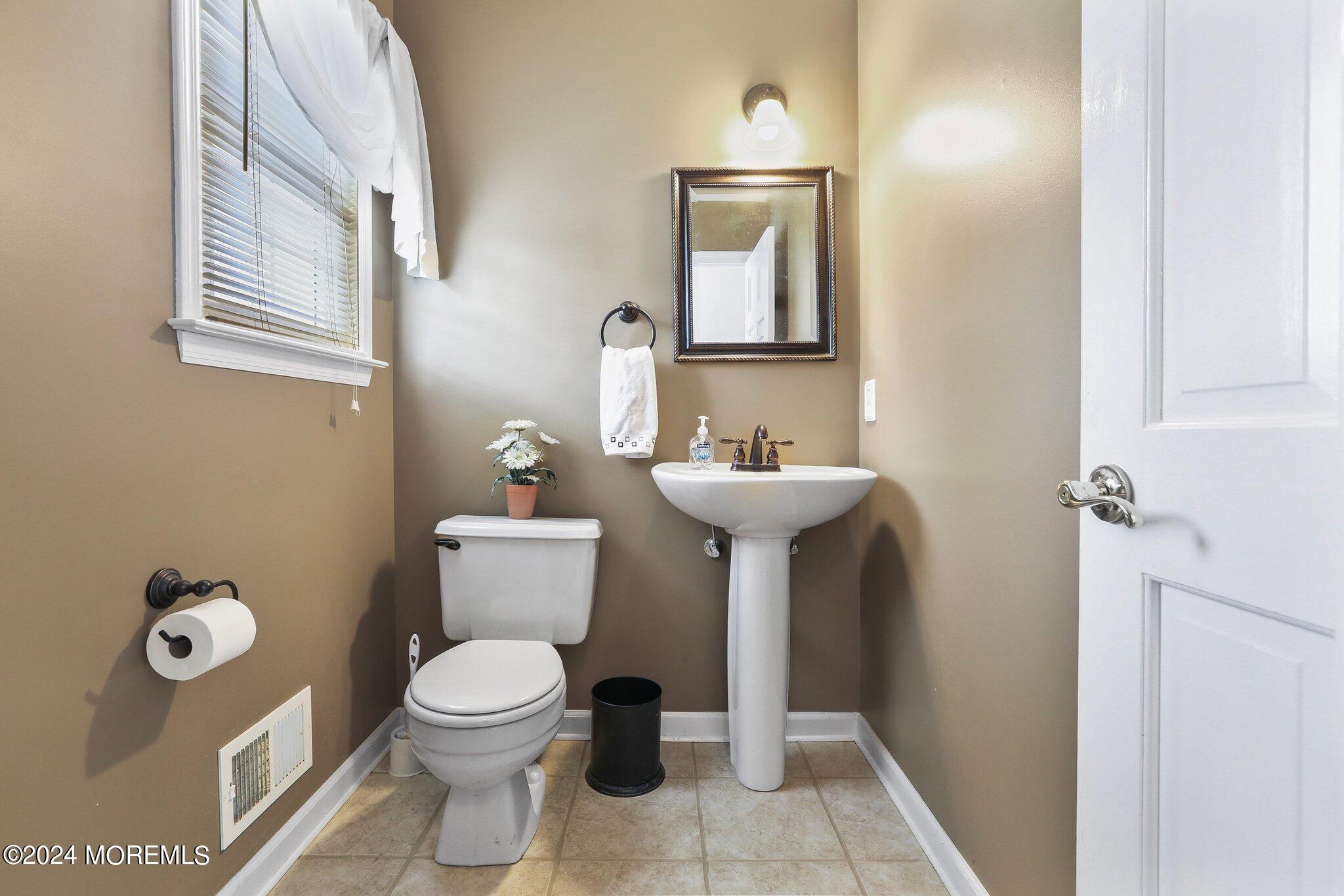 234 Yale Drive Lincroft, NJ 07738 - Photo 19 of 38 a bathroom with a toilet sink and mirror