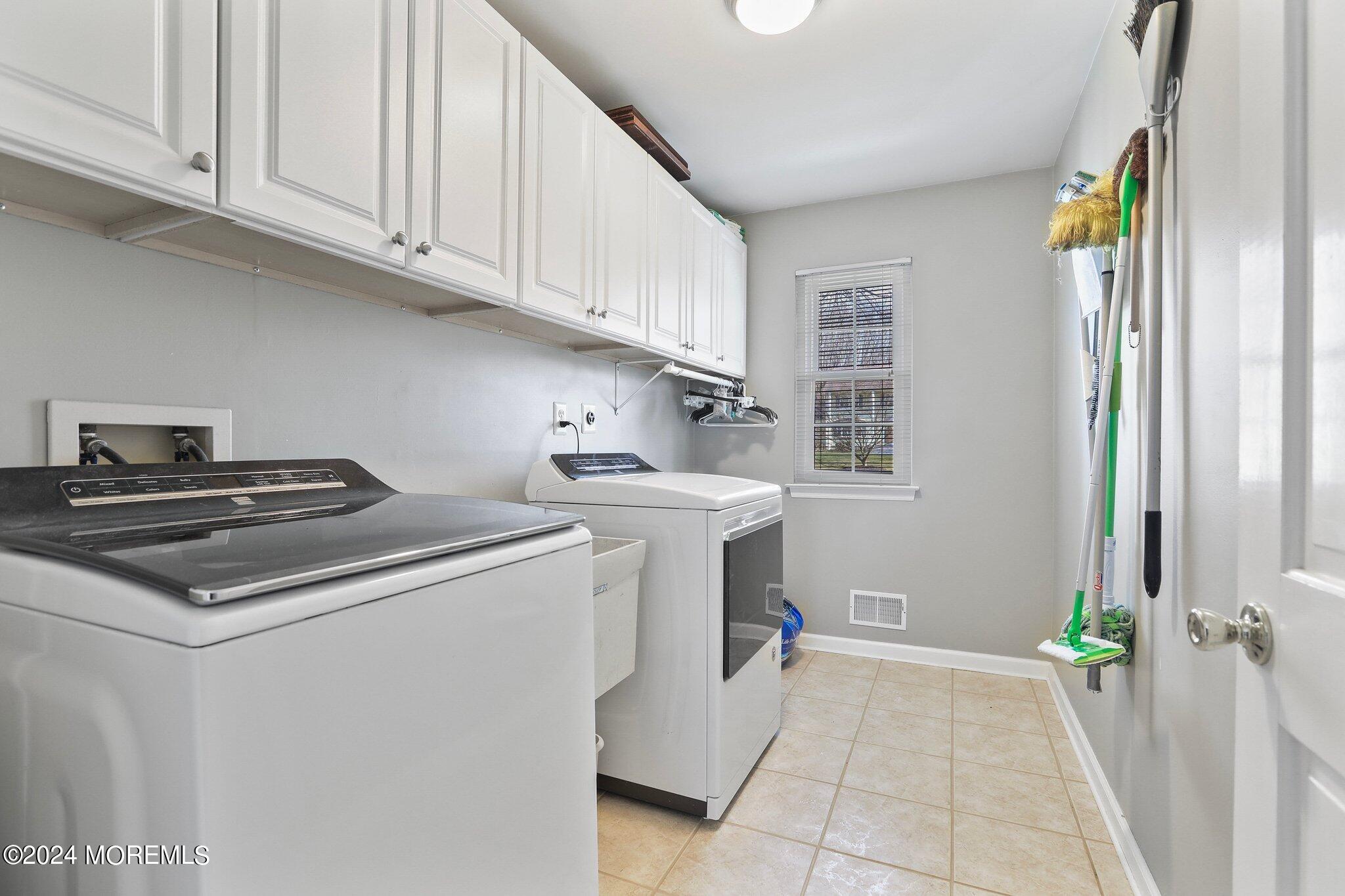 234 Yale Drive Lincroft, NJ 07738 - Photo 20 of 38 a kitchen with a sink stove and cabinets